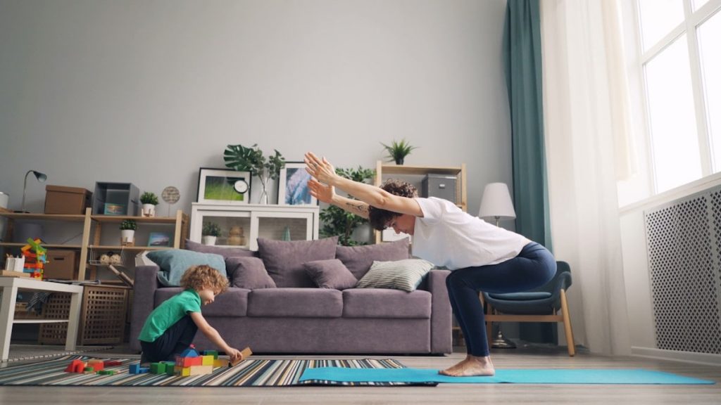a woman and a child playing in a living room